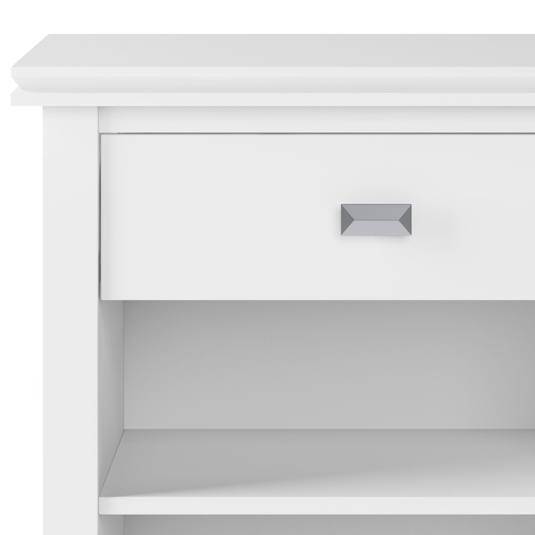 A close-up of the Artisan - Handcrafted Bedside Table shows a white, modern nightstand with one drawer featuring a rectangular silver handle and an open shelf below. Its minimalistic design adds elegance to any space.