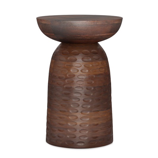 The Boyd Handcrafted Wooden Accent Table features a tall, round design with a wide circular top and a narrow, textured base adorned with raised dots, finished in a rust-brown metallic tone.