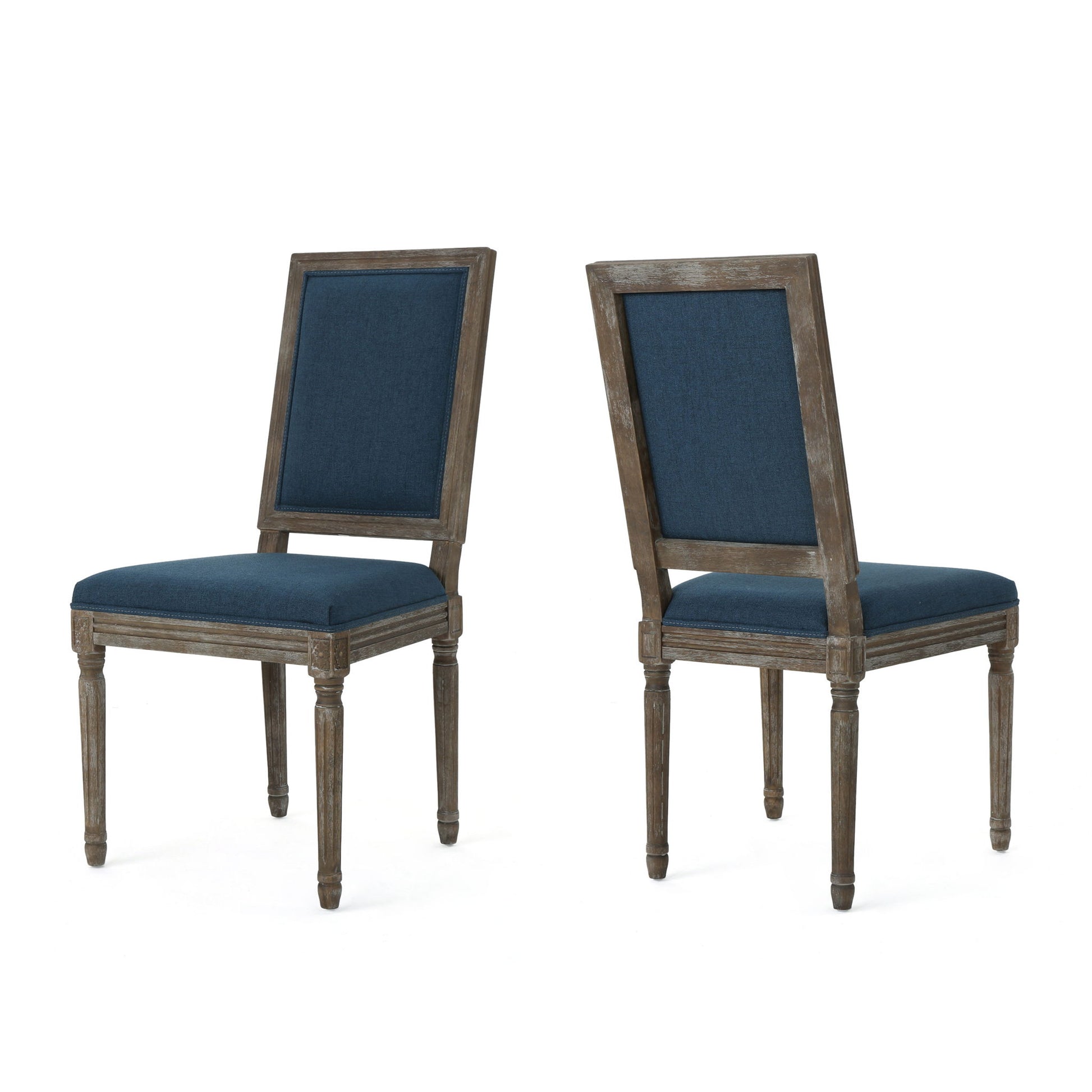 Set of two Traditional Style Dining Chairs with dark blue fabric upholstery, rustic weathered wood finish, square backs, and straight fluted legs. One chair is facing forward, the other is angled backward.