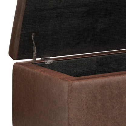 A close-up of the Hamilton - Upholstered Storage Ottoman, highlighting its hinged lid and spacious dark interior.