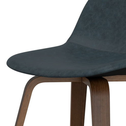 Close-up of the Randolph Bentwood Counter/Bar Height Stool, featuring a curved black seat and wooden legs. The minimalist design is showcased with only part of the seat and legs visible. Set includes 2 stools.