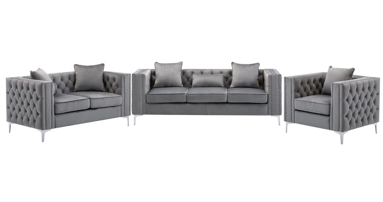 The Lorreto Velvet Fabric Living Room Set is a three-piece gray ensemble with tufted backs and silver legs, including a sofa, loveseat, and armchair, each featuring matching accent pillows.