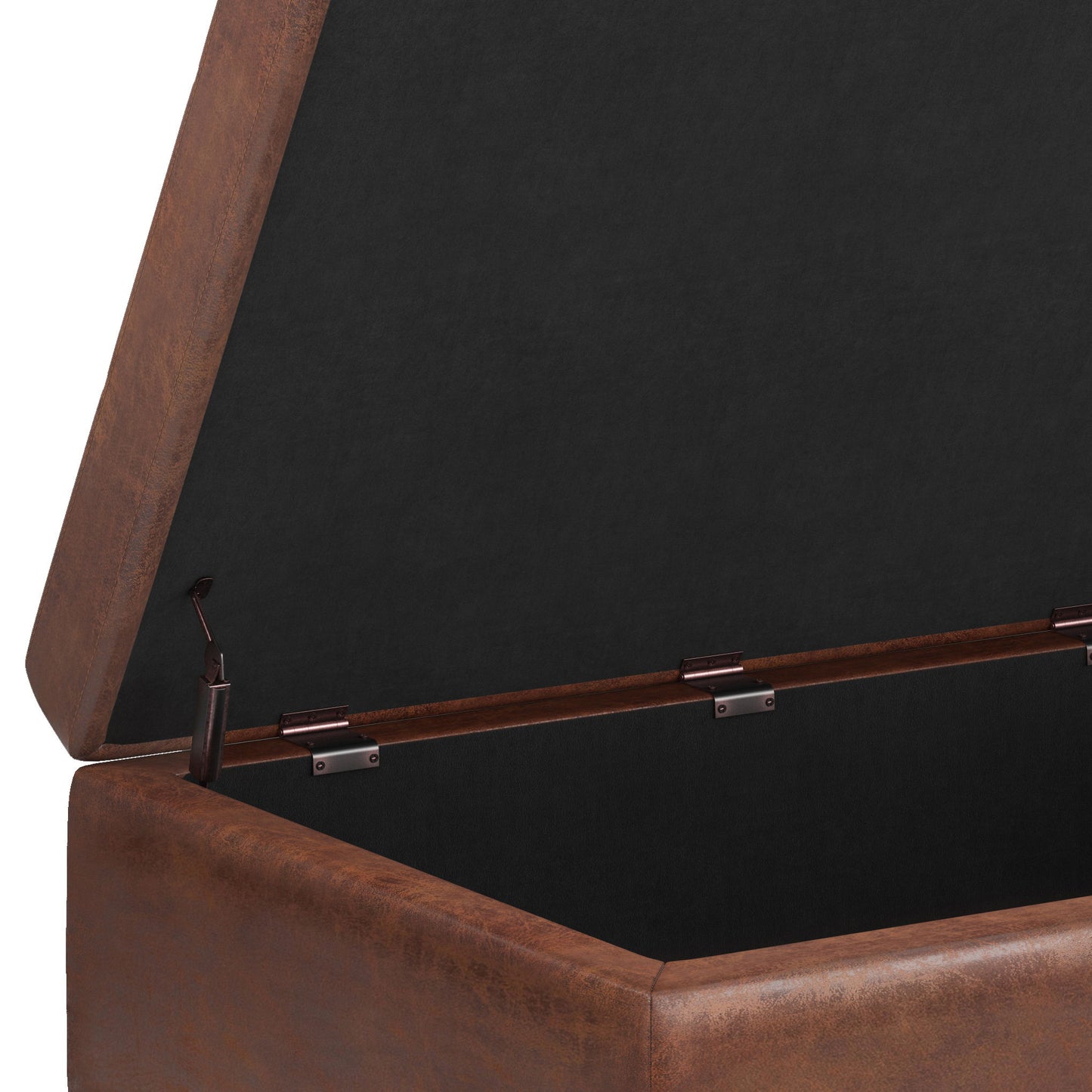 A close-up of the Shay Large Square Coffee Table Storage Ottoman in brown upholstery, open to reveal a black fabric-lined interior and metal hinges holding the lid upright in mid-century style.