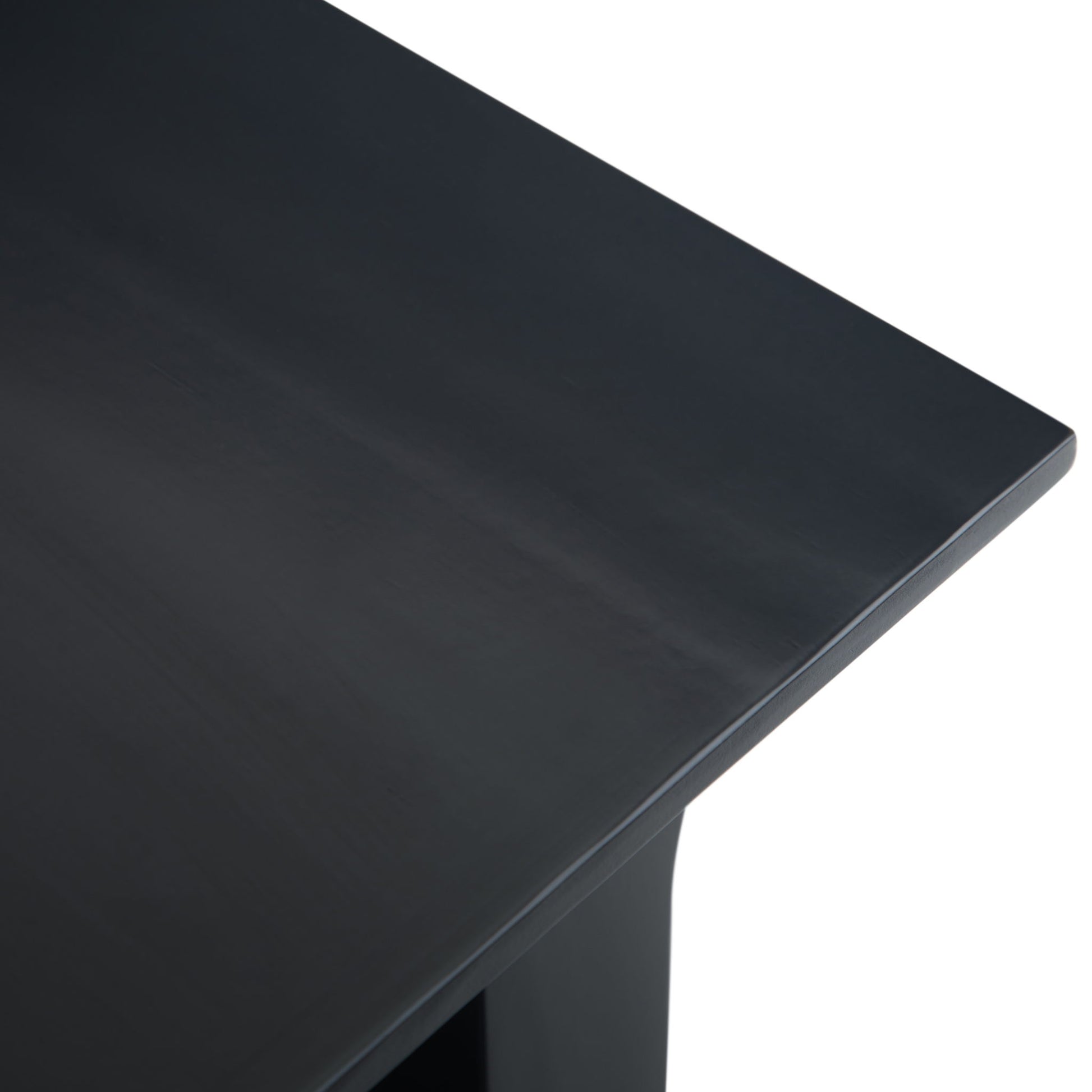 Close-up view of the top corner of the Acadian - Narrow Side Table, Handcrafted, featuring a sleek, dark finish with clean lines and a smooth, glossy surface.