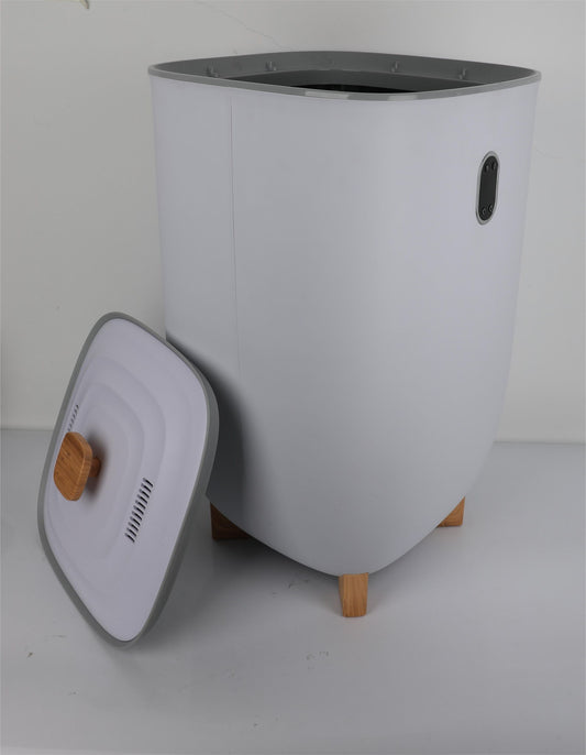 A modern, white Extra Large Towel Warmer with a rectangular shape and wooden legs. The matching lid with a wooden handle leans against the luxury bucket warmer, revealing its open top. Background is plain white.