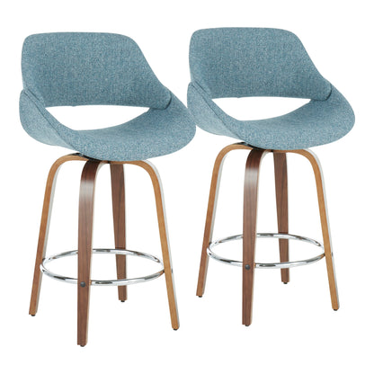 Set of 2 Fabrico mid-century modern counter stools featuring curved wooden legs, metal round footrests, and light blue upholstered seats and backs with an open lower back design.