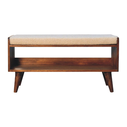 The Solid Wood Bench With Upholstered Seat features angled legs, a light-colored cushioned top, and an open lower shelf for storage.