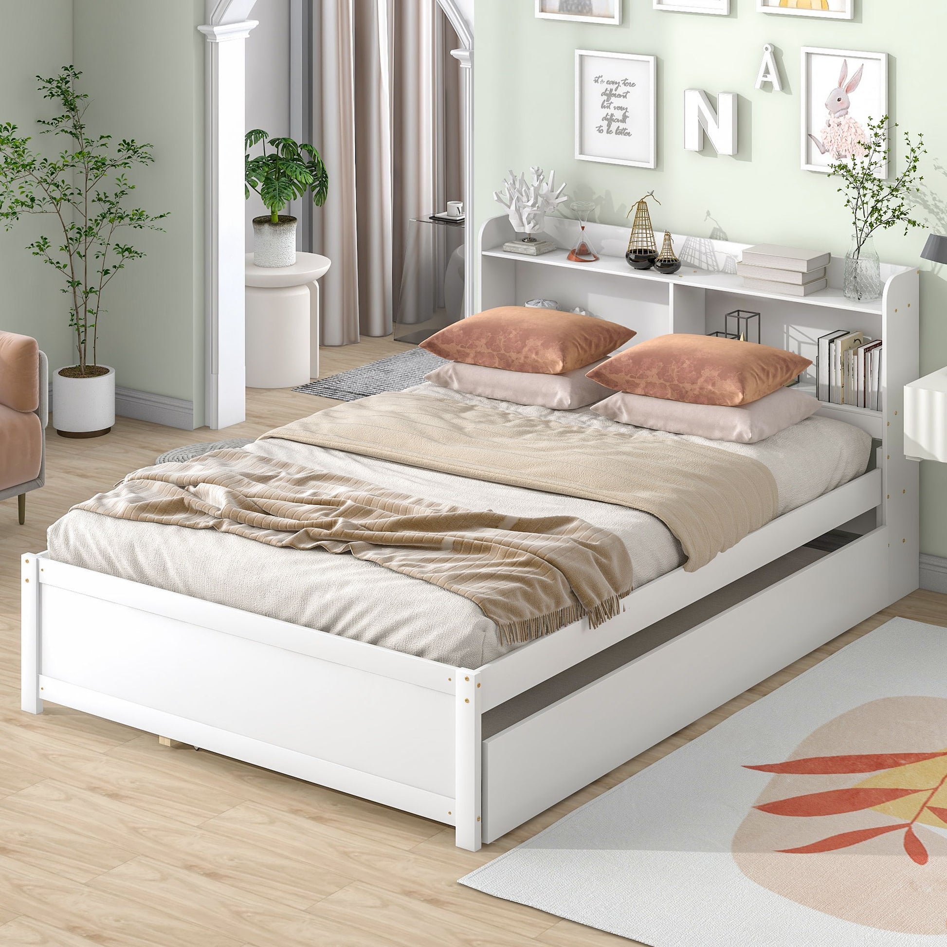A Full Bed With Trundle, Bookcase features beige bedding and two peach pillows in a bright bedroom. The bed’s headboard shelf holds decor, a pull-out trundle offers storage, and the room is styled with plants and framed art.