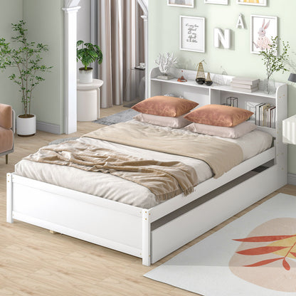A Full Bed With Trundle, Bookcase features beige bedding and two peach pillows in a bright bedroom. The bed’s headboard shelf holds decor, a pull-out trundle offers storage, and the room is styled with plants and framed art.