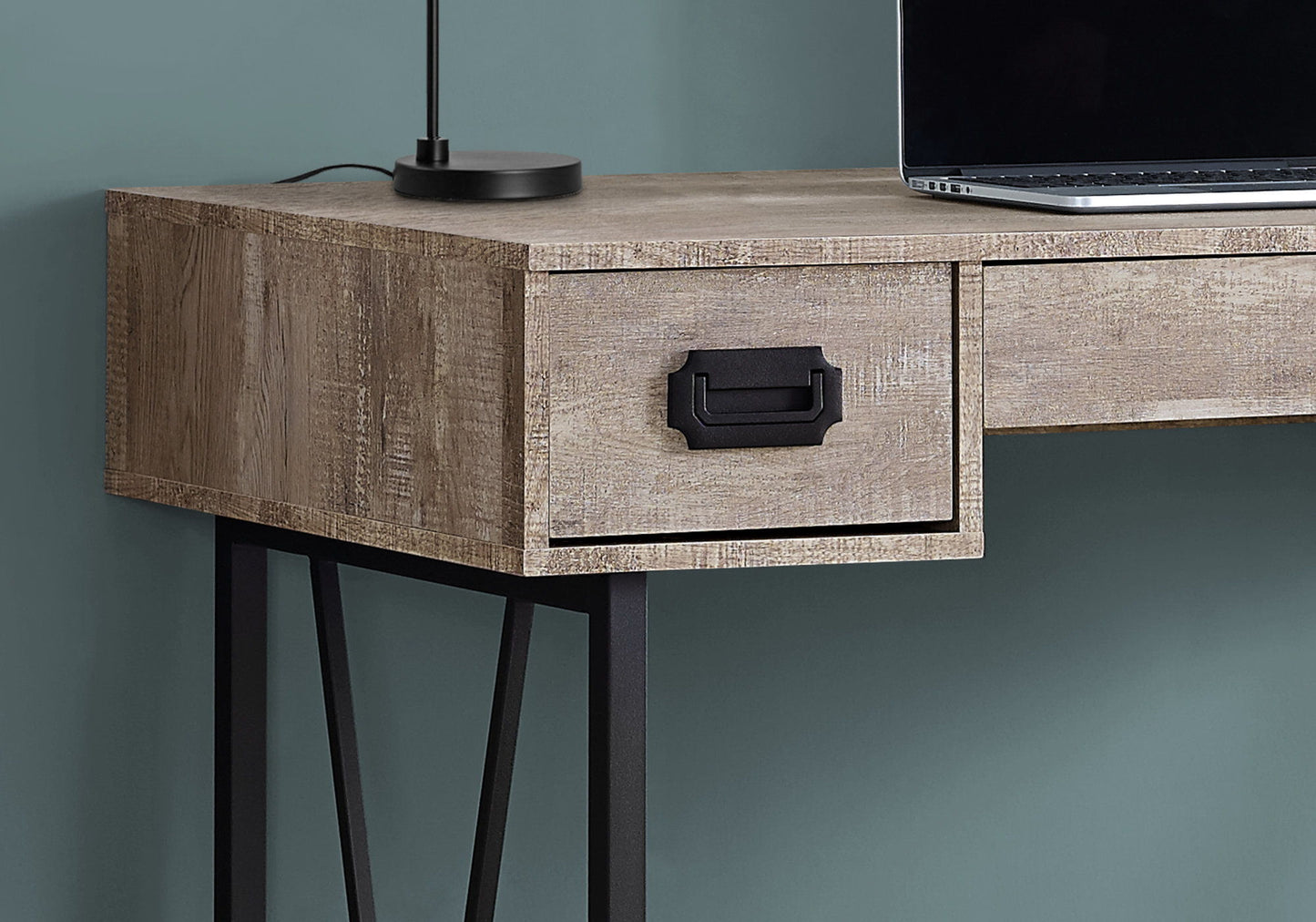 Close-up of the Computer Desk For Home Office with storage drawers and black handles, shown with a black lamp and open laptop on its wooden top, against a green wall. Ideal for laptops and home office use.
