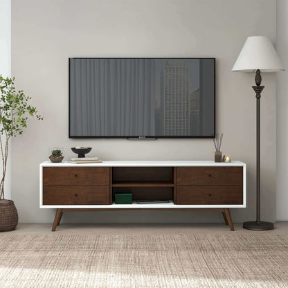 A flat-screen TV is mounted on a light wall above the Caroline - Modern TV Stand Up To 72" with drawers. A floor lamp and potted plant stand on either side, while a neutral rug completes the room.