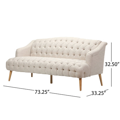 The Comfy 3 Seat Sofa With Wooden Legs, for living room and study, comes in beige with tufted design and measures 73.25"W x 33.25"D x 32.5"H.