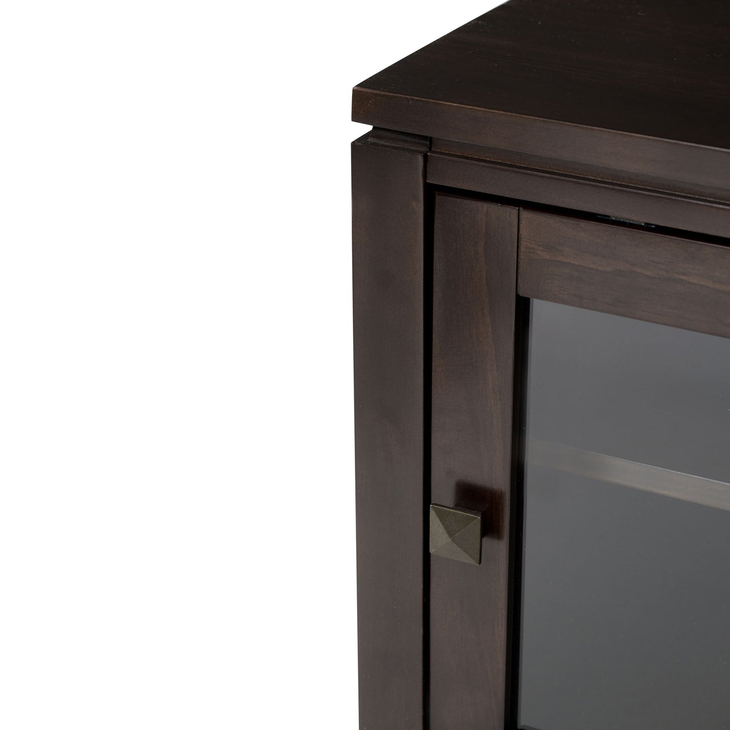 Close-up of the top corner of the Cosmopolitan - Handcrafted Medium Storage Cabinet, featuring a dark wood finish, glass door, small square metal handle, clean straight lines, and a smooth surface.