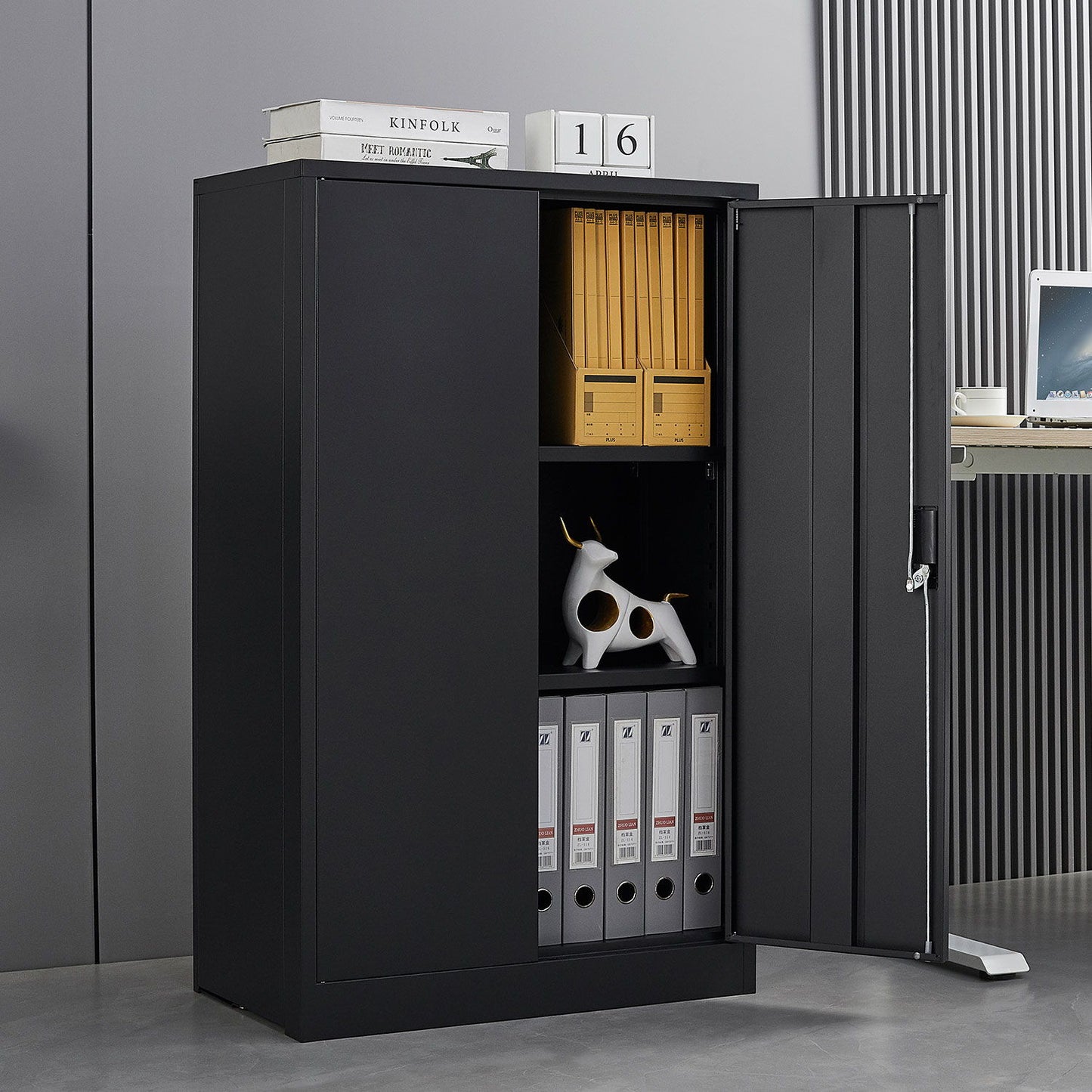 A Metal Storage Cabinet With Locking Doors and Adjustable Shelf stands open, displaying shelves with folders, binders, and a white dog figurine. A box and a "16" calendar are on top, next to a desk with a laptop.