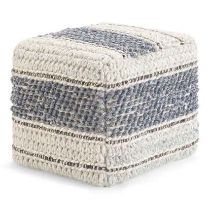 The Grady - Handcrafted Square Pouf features a chunky knit texture with horizontal stripes in cream, blue, and gray yarn, giving it a soft, cozy look and a modern, artisanal style.