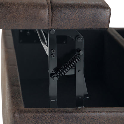 Close-up of the Harrison Large Coffee Table Storage Ottoman in brown faux leather, with the lid open to reveal the black metal hinge and spring mechanism inside the compartment.