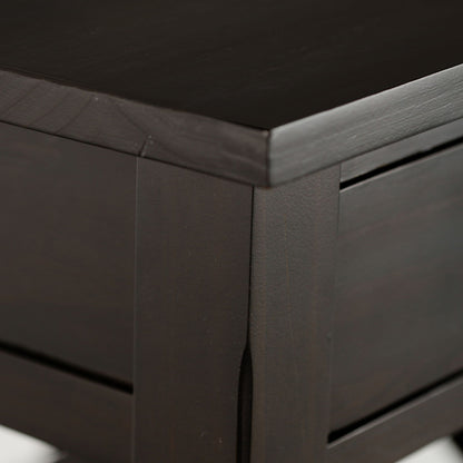 Close-up of the Kitchener - Handcrafted Table’s corner, highlighting its smooth, polished dark wood surface and clean, modern lines.