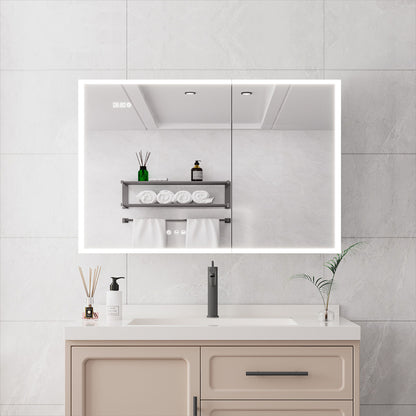 A modern bathroom features a beige vanity, white countertop, and a Bathroom Medicine Cabinet With Lights—a LED mirror cabinet with defogger—reflecting shelves with towels and toiletries. Minimalist decor includes a soap dispenser and reed diffuser.