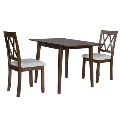 The 3 Piece Kitchen Dining Set includes a brown drop leaf dining table and two upholstered chairs with crisscross backrests and light cushioned seats, perfect for small spaces.