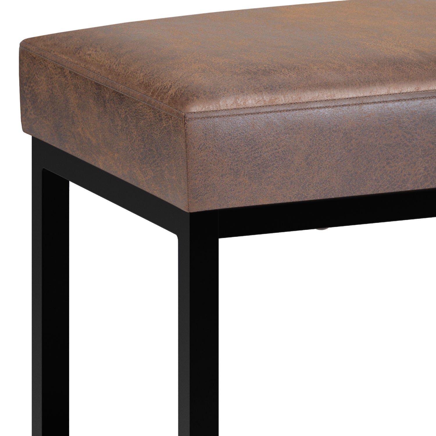 Close-up of the Reynolds Small Bench in Distressed Chestnut Brown, highlighting its cushioned faux leather seat and black metal legs at the corner and side.