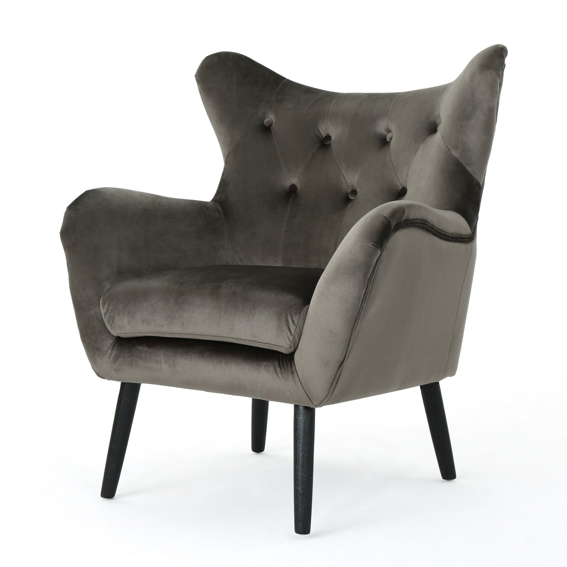 The Alyssa Mid Century Upholstered Arm Chair features a wingback design, dark wooden legs, soft dark gray velvet upholstery, a tufted backrest, and wide curved armrests.