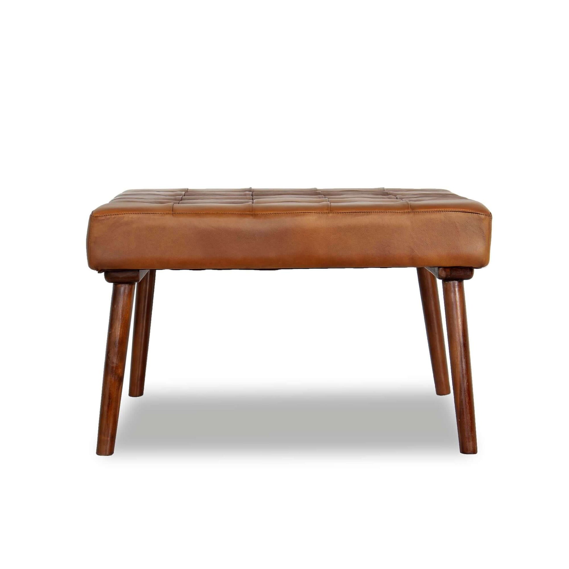 The Mark Tufted Square Genuine Leather Upholstered Ottoman features brown leather, tufted detailing, and four angled wooden legs, shown against a white background.