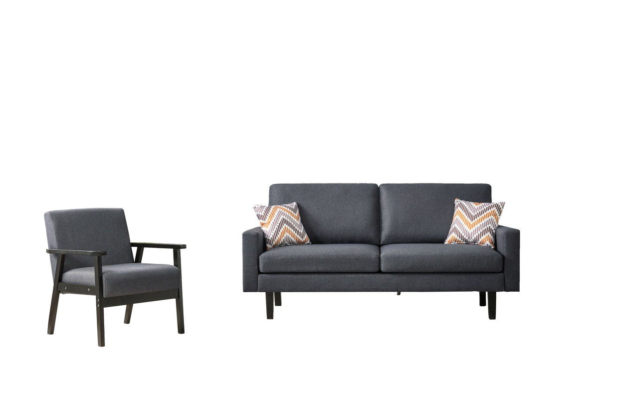 The Bahamas Sofa Set features a dark gray armchair and matching two-seater sofa with wooden legs and modern lines. The sofa includes two patterned throw pillows in white, brown, and orange against a plain white background.