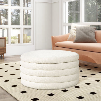 A modern living room with a large window, tan sofa with throw pillows, and the Fuji Oversized Round Storage Ottoman in white on a beige rug featuring black square patterns.