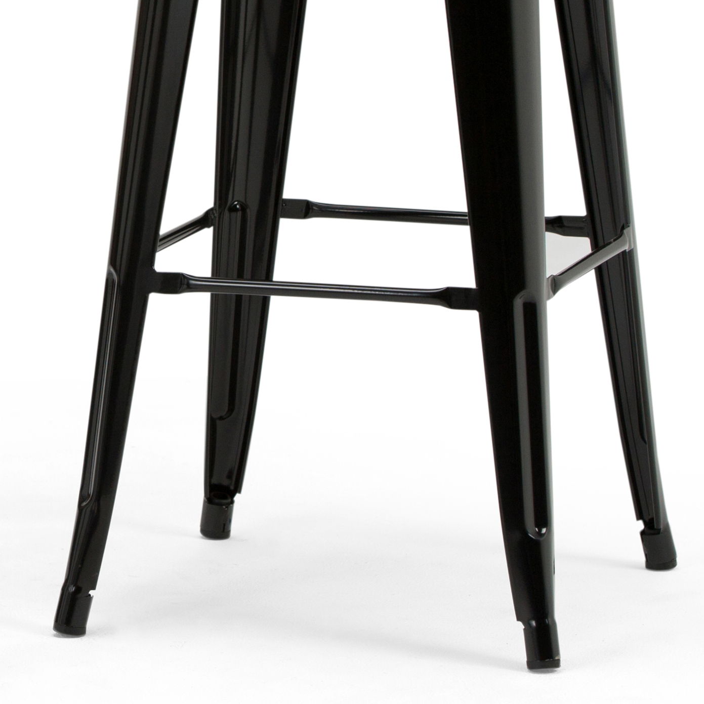 Close-up of the black metal legs and footrest bars of the Rayne - Multifunctional Metal Stool, set against a white background.