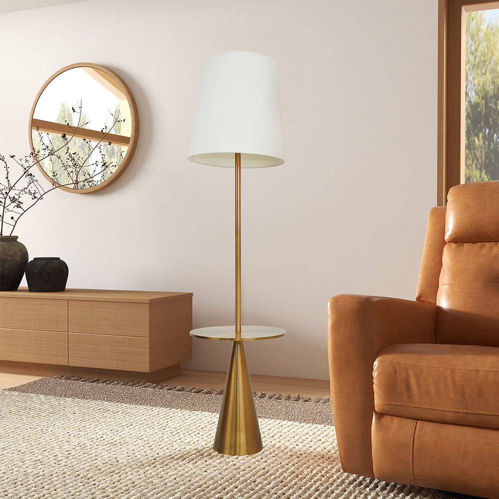 A modern living room featuring the Celestial Modern Floor Lamp with Accent Table in gold and white, a tan leather armchair, wooden sideboard, decorative vases, circular wall mirror, and a window streaming natural light.
