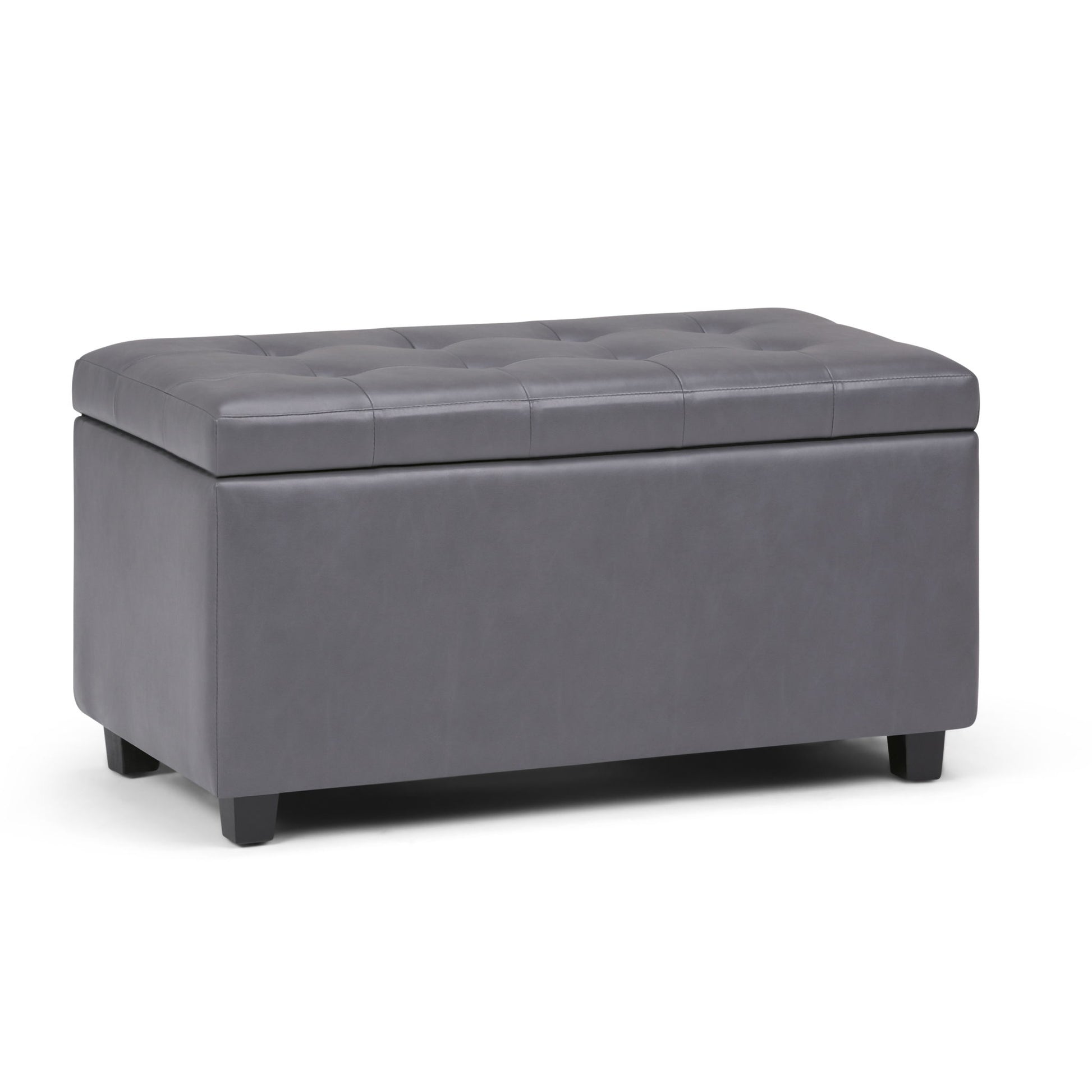 The Cosmopolitan Upholstered Storage Ottoman is rectangular, features a tufted dark gray faux leather design with short black legs, and has a hinged top that lifts for convenient storage inside.