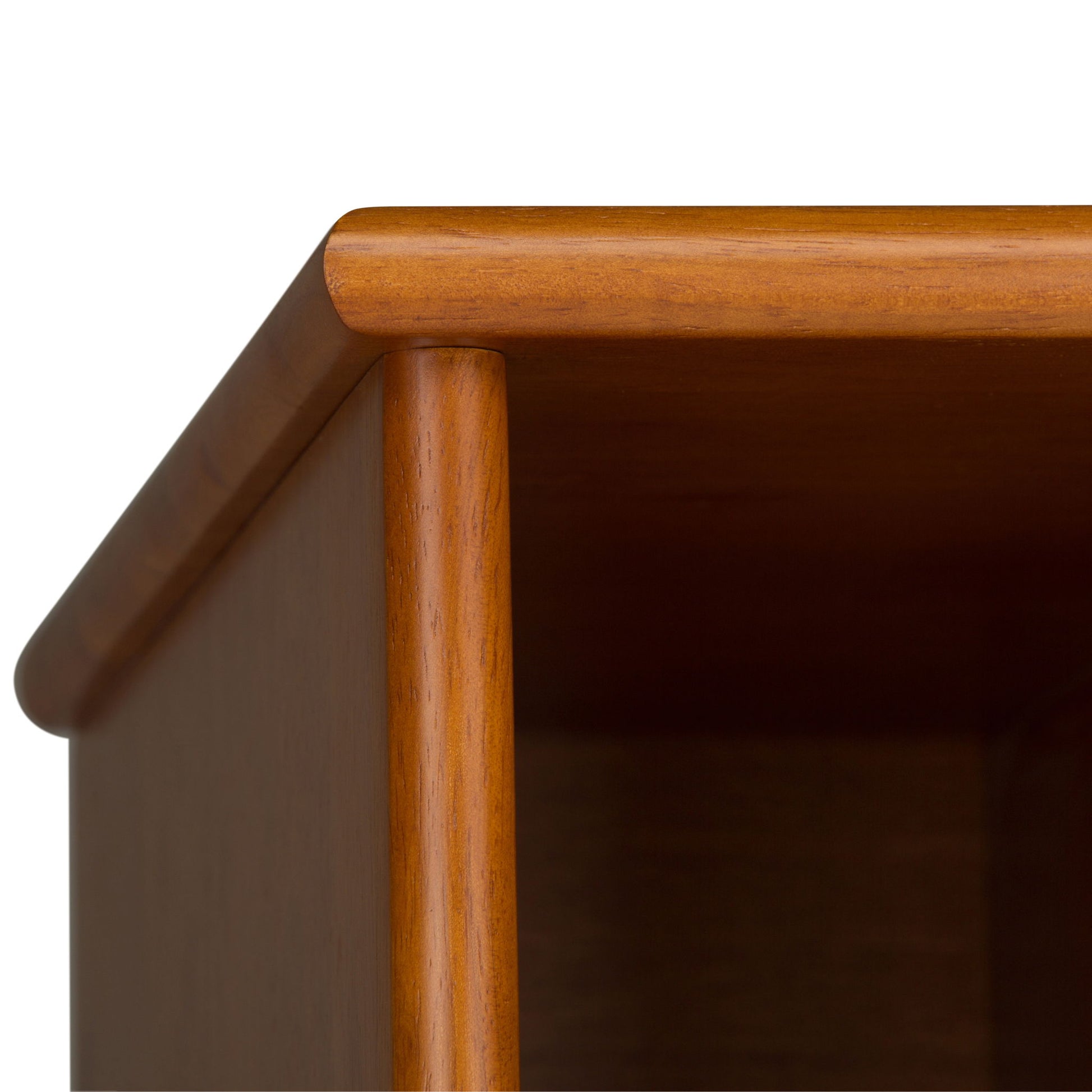 Close-up of the top corner of the Draper - Mid Century Wide Bookcase And Storage Unit, featuring a smooth, rounded edge and warm brown finish, set against a plain white background.