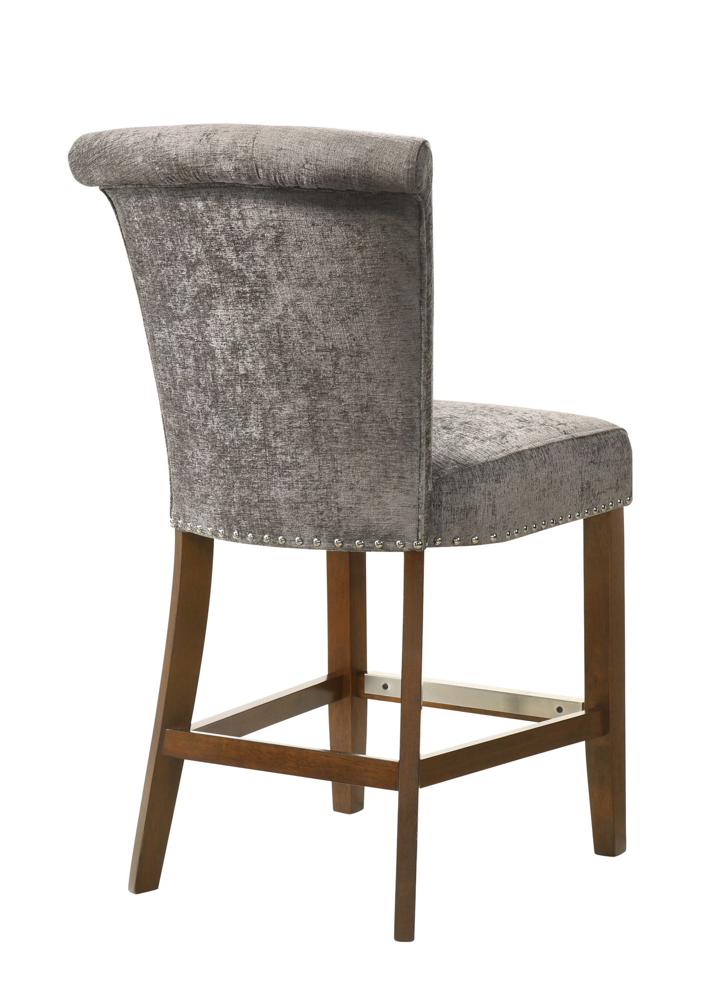 The Auggie 20.5" Fabric Counter Height Chair features gray upholstery, a high slightly rolled back, nailhead trim, and wooden legs with a crossbar footrest, shown from a rear side angle.