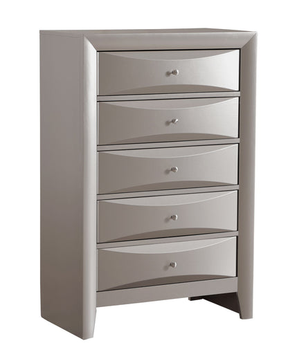The Marilla Chest is a tall, modern silver dresser with six drawers, each adorned with a small round knob and subtle wave-shaped designs on the drawer fronts.