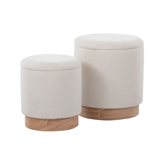 The Marla Contemporary Nesting Ottoman Set includes two round, beige fabric ottomans with removable lids and light wooden bases. The larger ottoman nests slightly behind and to the right of the smaller one.