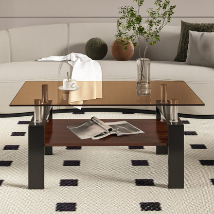 A modern living room features the Modern Rectangular Coffee Table With Tempered Glass Top, displaying a vase with green branches, a cup and saucer, and a white cloth. An open magazine rests on the wooden shelf below; a sofa with pillows is behind.