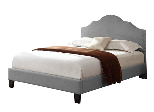 The Kopa - Fabric Upholstered Bed in queen size features a light gray frame, arched headboard, white bedding, two pillows, and a brown throw blanket draped at the foot.