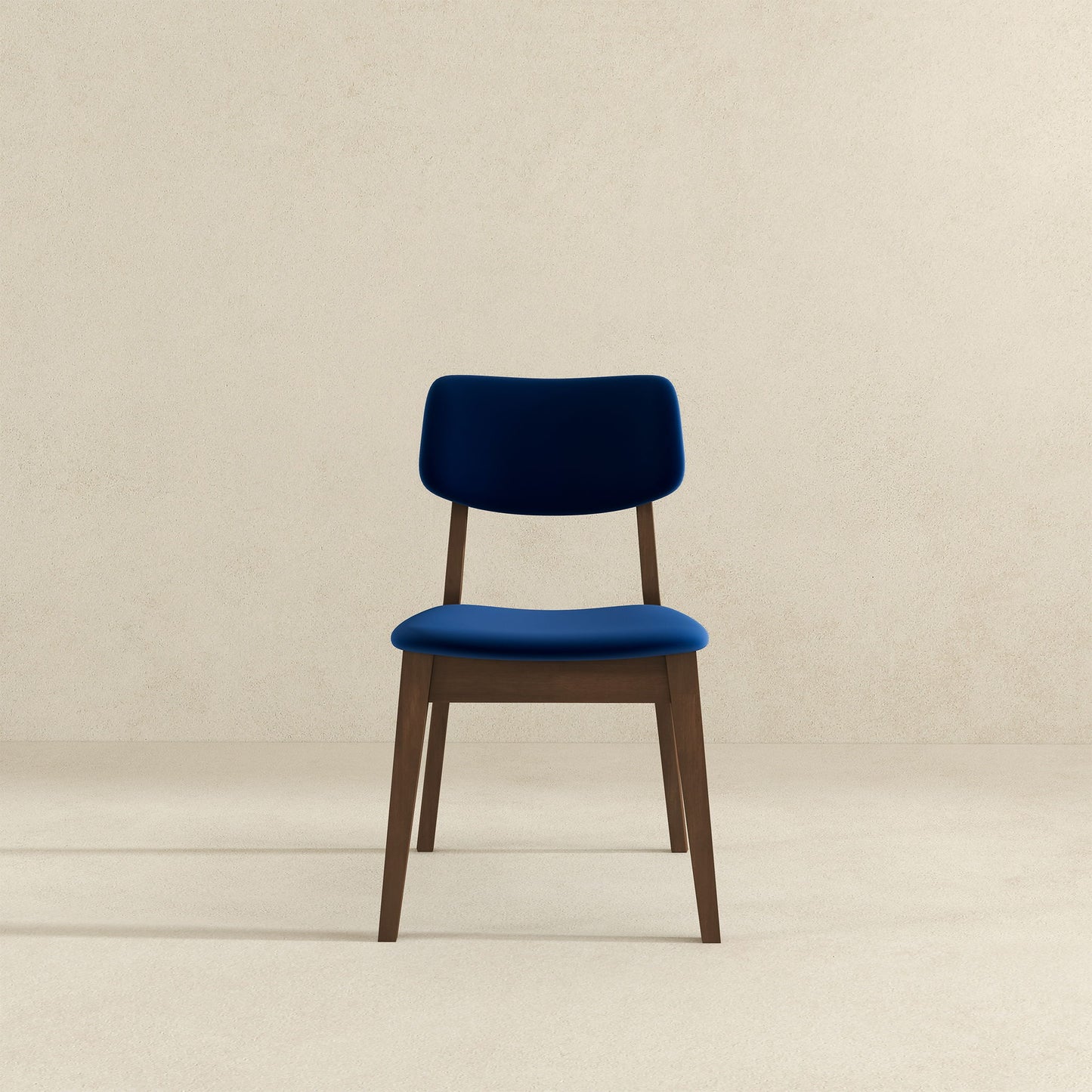 A Carlos Solid Back Side Chair (Set of 2) with blue upholstered seat and backrest is centered against a plain, light beige background.