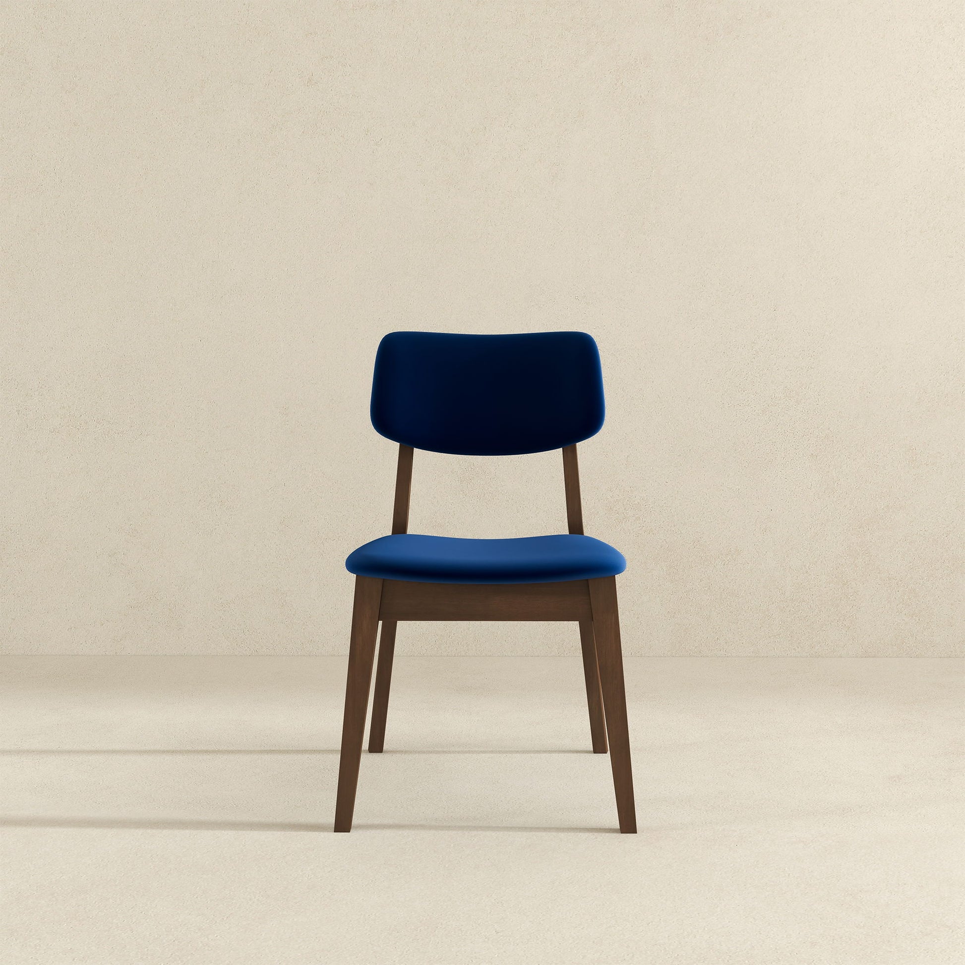 A Carlos Solid Back Side Chair (Set of 2) with blue upholstered seat and backrest is centered against a plain, light beige background.