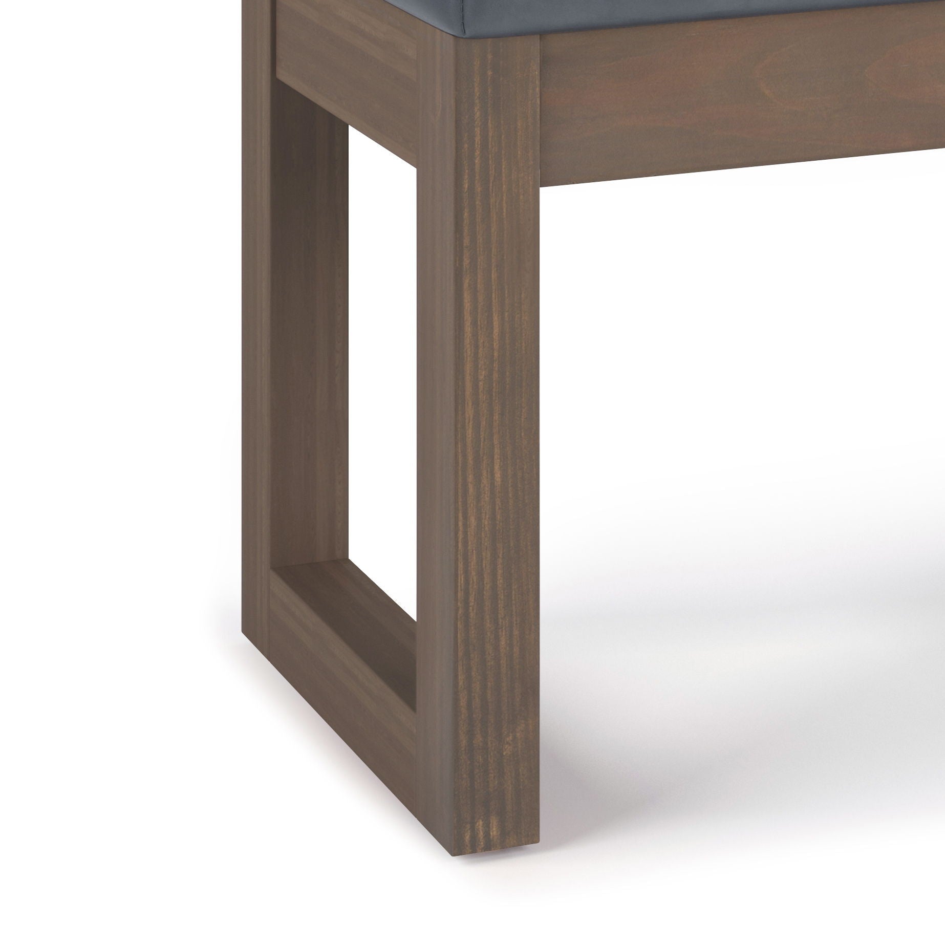 Close-up of the Milltown - Upholstered Ottoman Bench corner leg: rectangular open-frame in smooth dark brown wood, topped with a dark upholstered cushion. Plain white background.