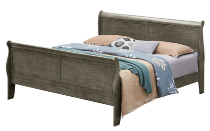 A Panel Sleigh Bed with a gray finish, styled with beige and blue bedding, a textured teal blanket, and several pillows, including one featuring a floral design.