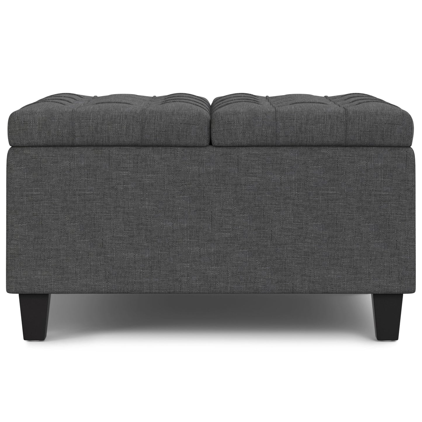 The Harrison Upholstered Coffee Table Storage Ottoman is rectangular, dark gray with a tufted top and short black legs, pictured against a white background.