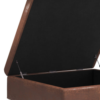 A close-up view of the Shay Large Square Coffee Table Storage Ottoman in brown faux leather with a hinged black lid, showcasing its spacious interior compartment and mid-century style.