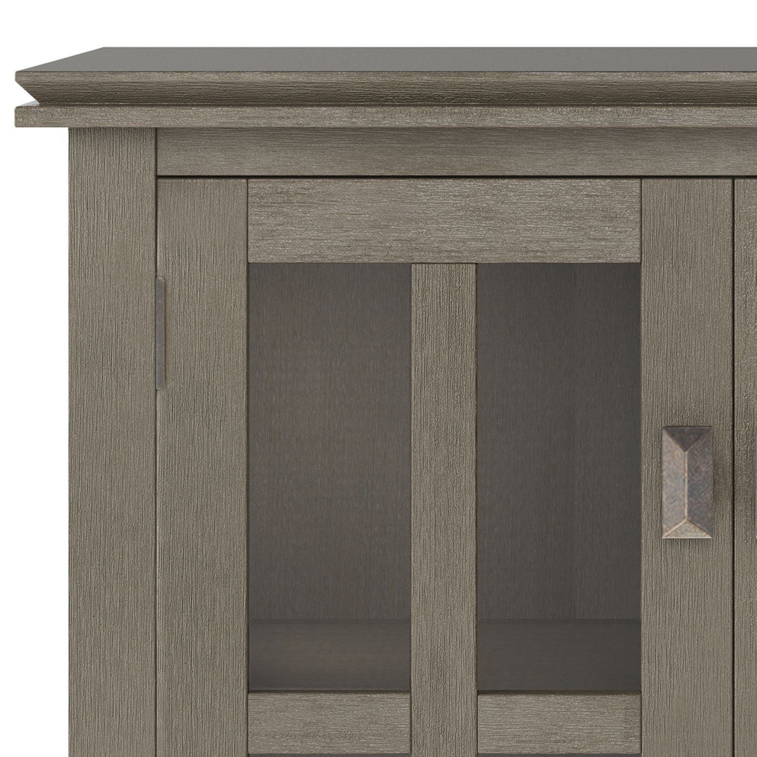 Close-up of the upper left corner of the Artisan - Handcrafted Low Storage Cabinet, showcasing its textured gray finish, glass doors with metal handles, and modern rectangular design.