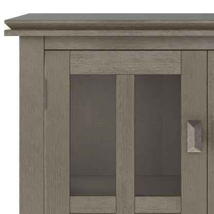 Close-up of the upper left corner of the Artisan - Handcrafted Low Storage Cabinet, showcasing its textured gray finish, glass doors with metal handles, and modern rectangular design.
