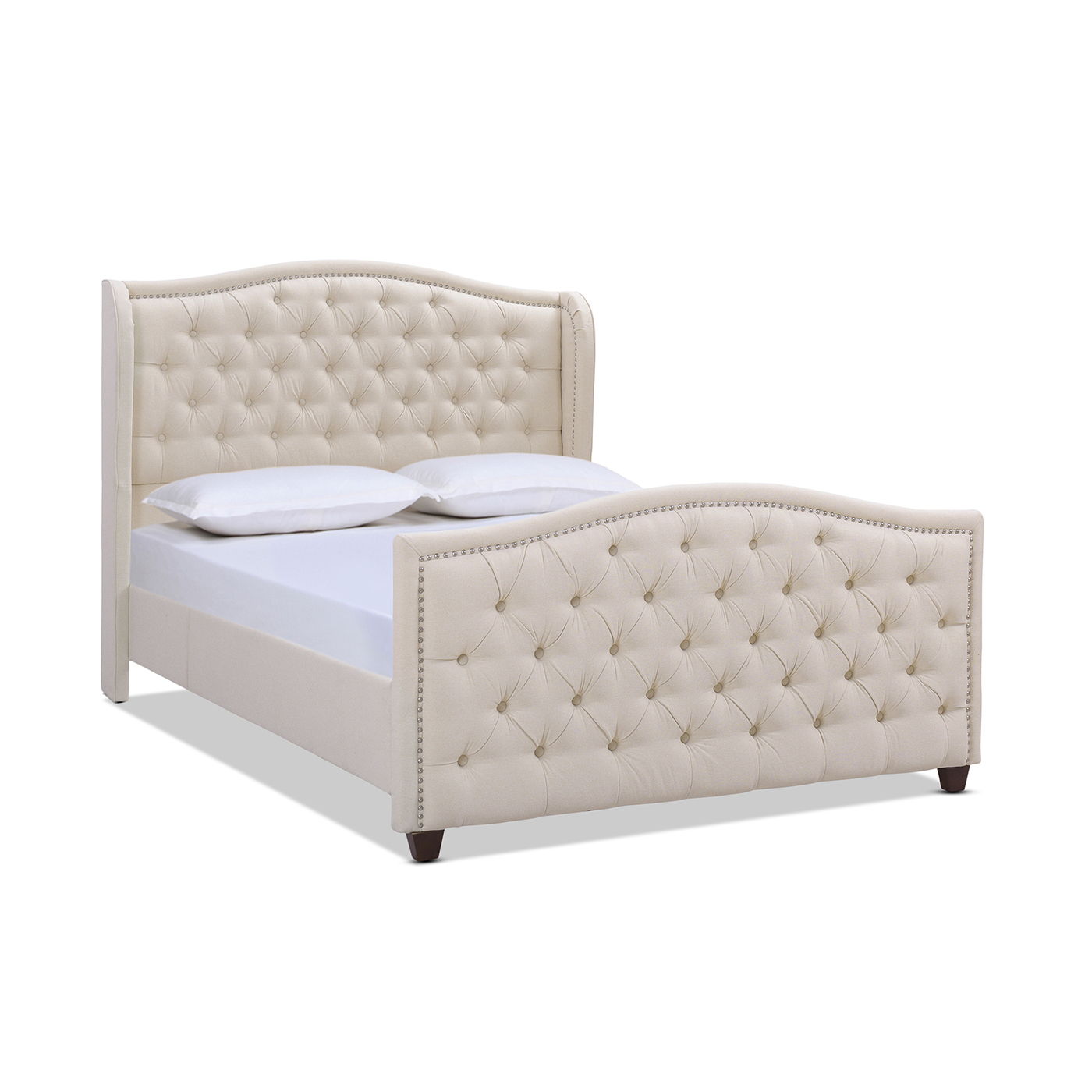 The Marcella Upholstered Shelter Headboard Bed Set features a beige tufted headboard and footboard with button details and curved edges, shown neatly made with white pillows and bedding.