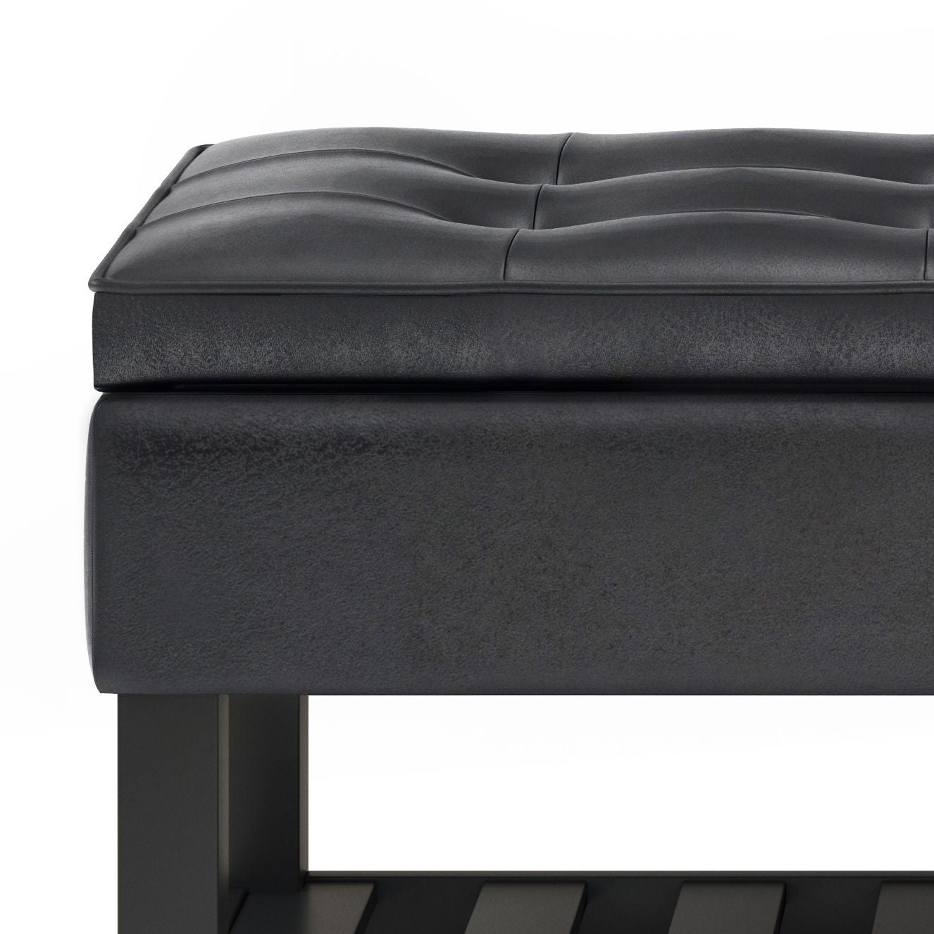 Close-up of the Cosmopolitan - Storage Ottoman Bench With Open Bottom, featuring a modern black tufted cushioned seat, smooth rectangular edges, and a sturdy frame with part of the lower open shelf visible.
