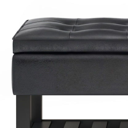 Close-up of the Cosmopolitan - Storage Ottoman Bench With Open Bottom, featuring a modern black tufted cushioned seat, smooth rectangular edges, and a sturdy frame with part of the lower open shelf visible.