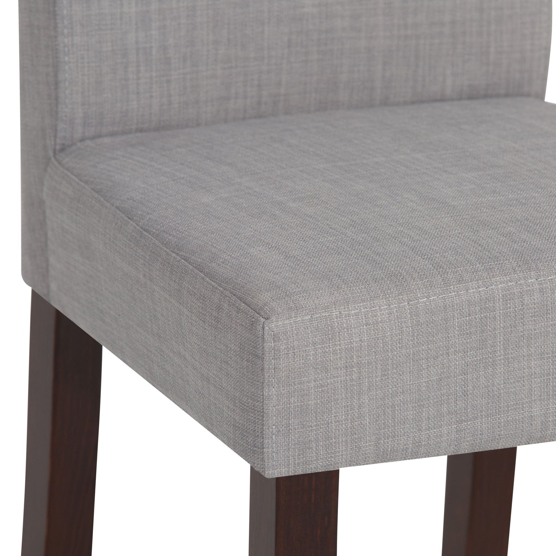 Close-up of the Acadian - Upholstered Parson Dining Chair (Set of 2), featuring a light gray textured fabric seat and backrest with dark wooden legs.