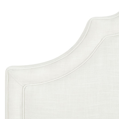 Close-up of the upper corner of the Catherine - Luxurious Comfort Upholstered Headboard, featuring light-colored fabric, a curved decorative edge, and visible stitching details.